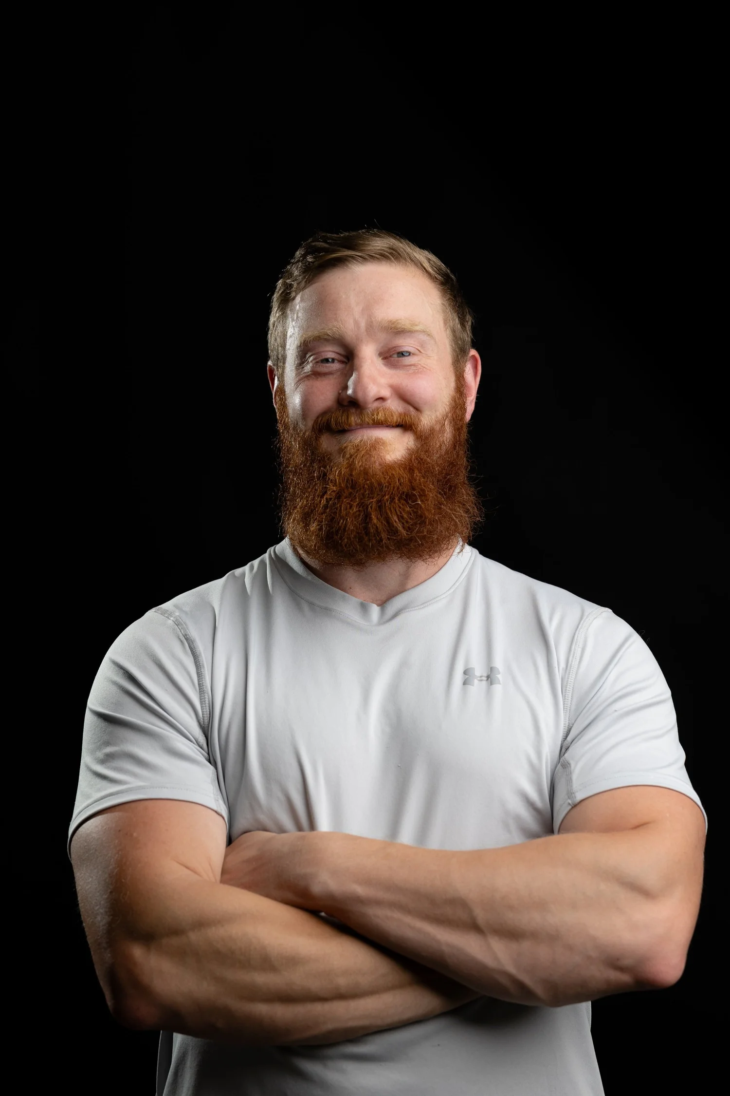 A confident, natural portrait against a black background